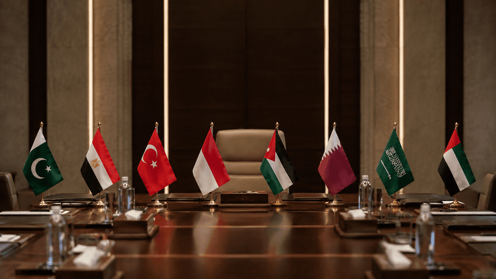 Flags of eight Arab and Muslim countries arranged around a diplomatic conference table